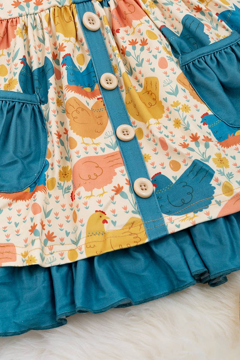 HEN PRINTED DRESS WITH TEAL POCKETS & RUFFLE HEM. LOI: L