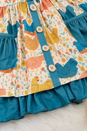 HEN PRINTED DRESS WITH TEAL POCKETS & RUFFLE HEM. LOI: 3XL
