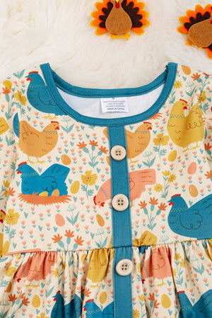 HEN PRINTED DRESS WITH TEAL POCKETS & RUFFLE HEM. LOI: L